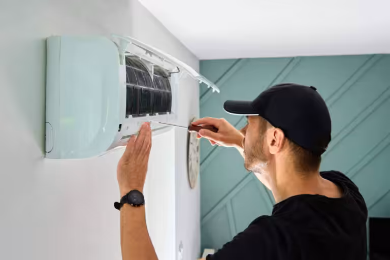 Technician repairing air conditioning unit