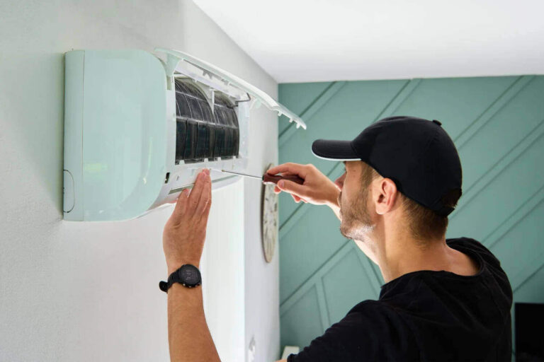 Technician repairing air conditioning unit