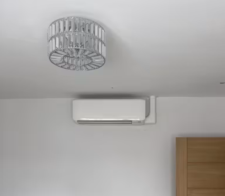Ceiling light and air conditioning unit on wall