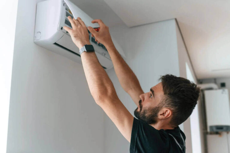 Man fixing a wall-mounted air conditioner