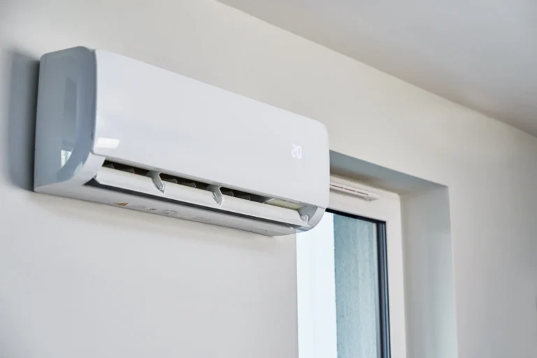 Wall-mounted air conditioner unit near window