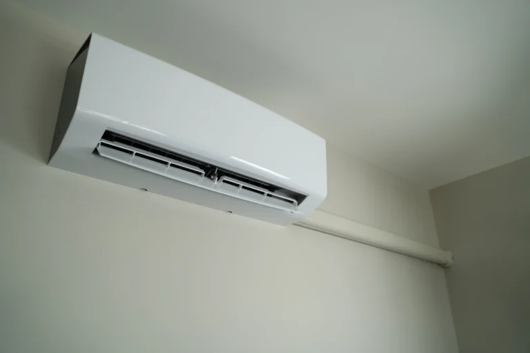 Wall-mounted air conditioning unit near ceiling